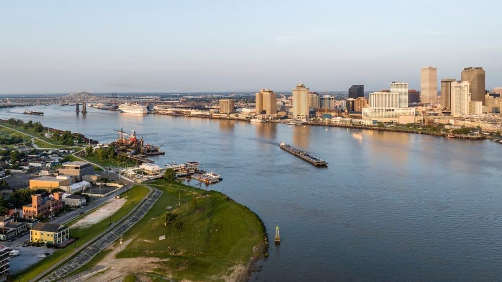 a river running through a city next to tall buildings